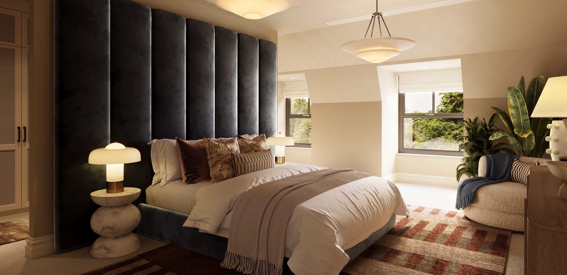 A view of a bedside, rug beneath, armchair next to window and walk-in wardrobe behind partition.