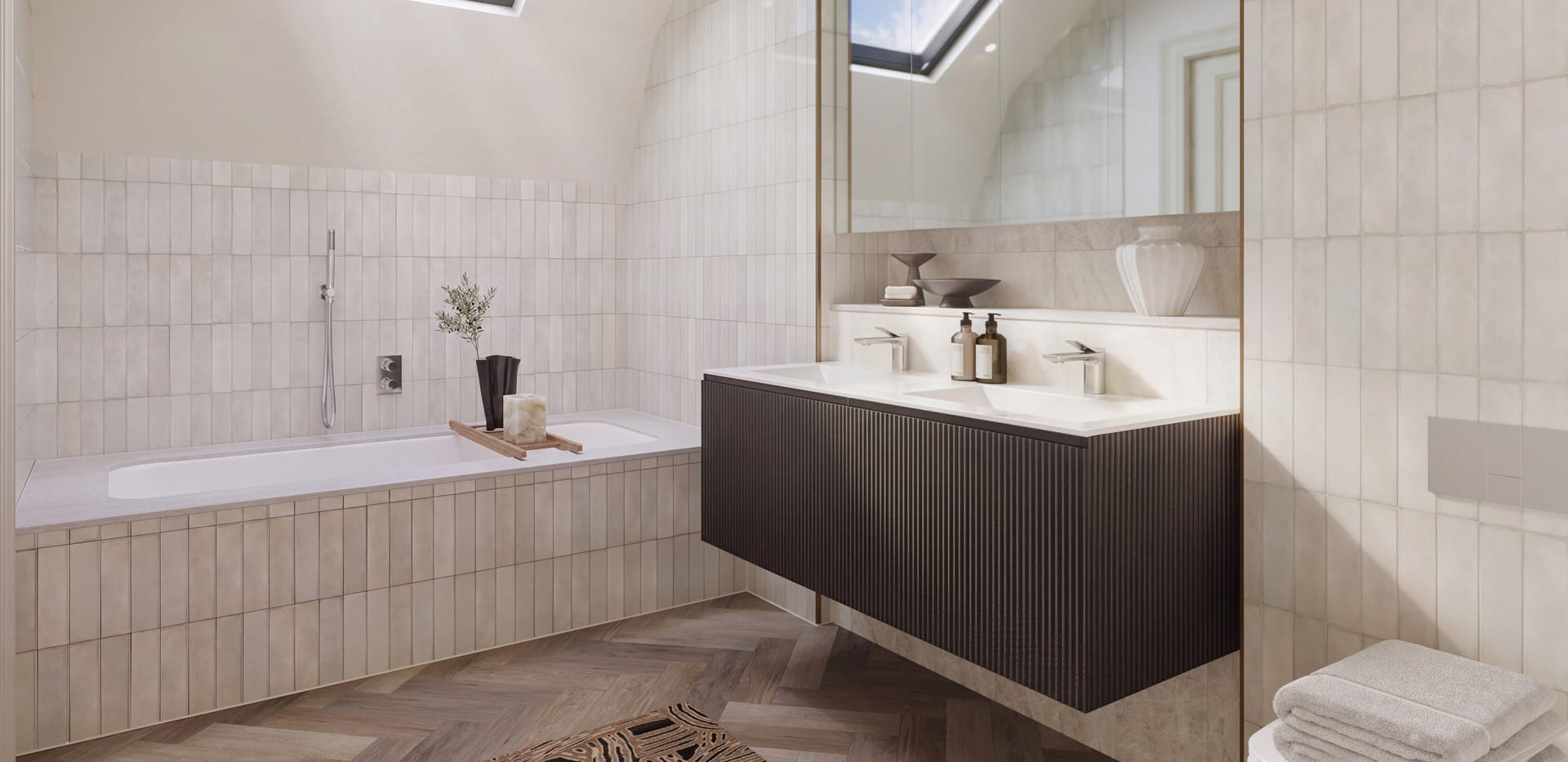 Bathroom with bath, grey tiling, wide wash basin with wide mirror above.