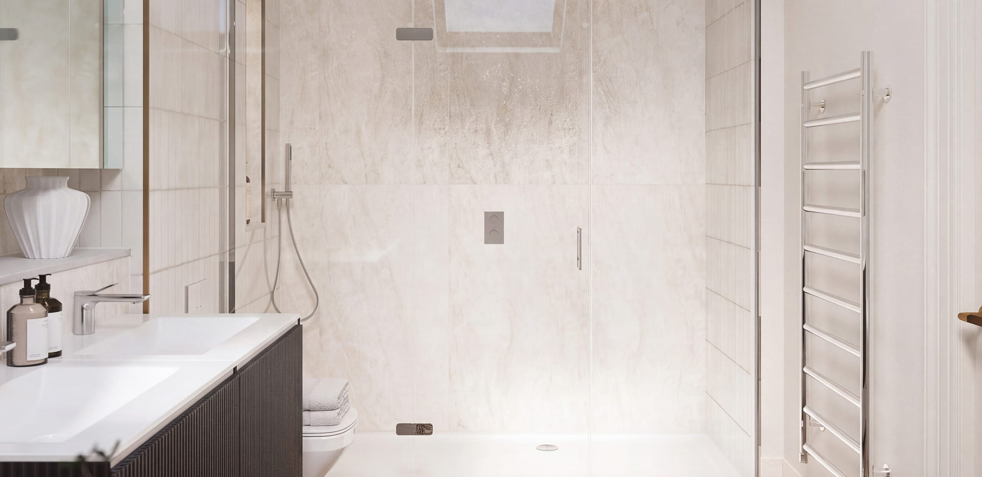 View of a wash basin, heated towel rack, shower unit, light grey and off-white tiling.