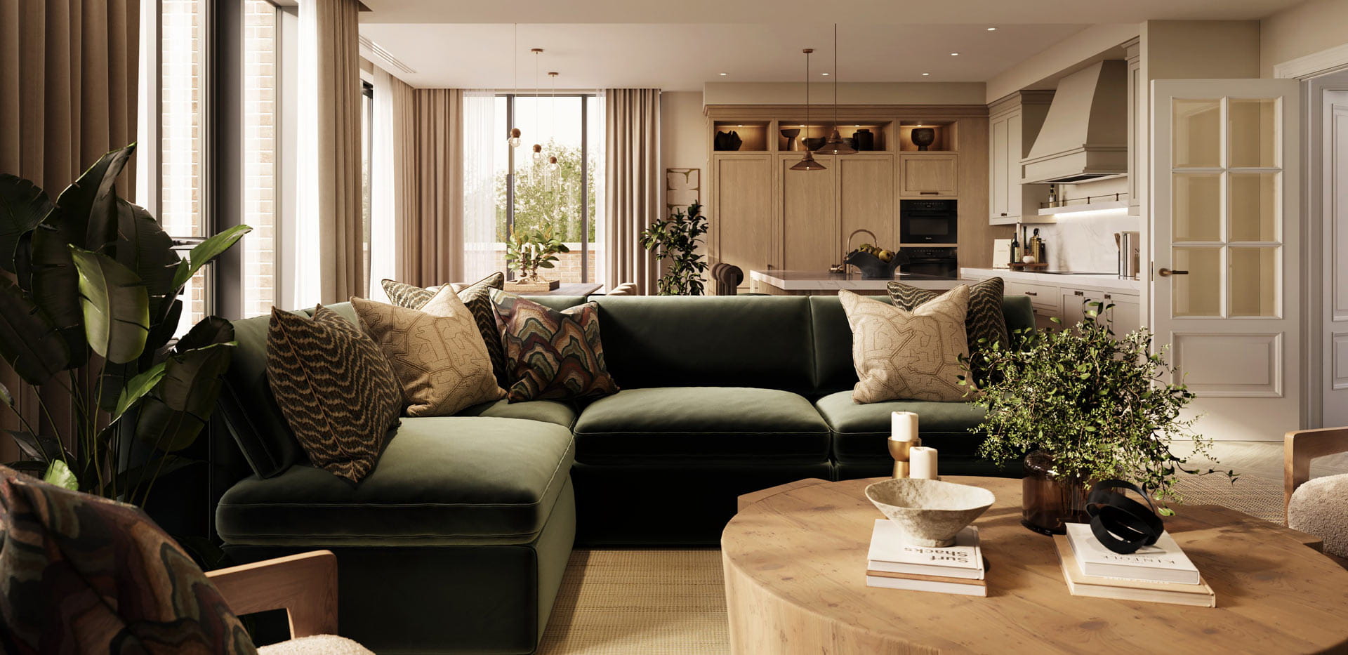 Living space with L-shaped, dark green sofa, round coffee table, kitchen in background
