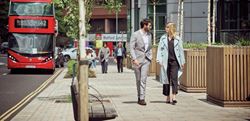 Business man and woman walking through the business park