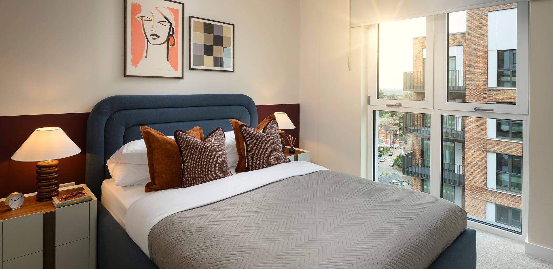 Double bed with modern design, bedside tables and wall hanging
