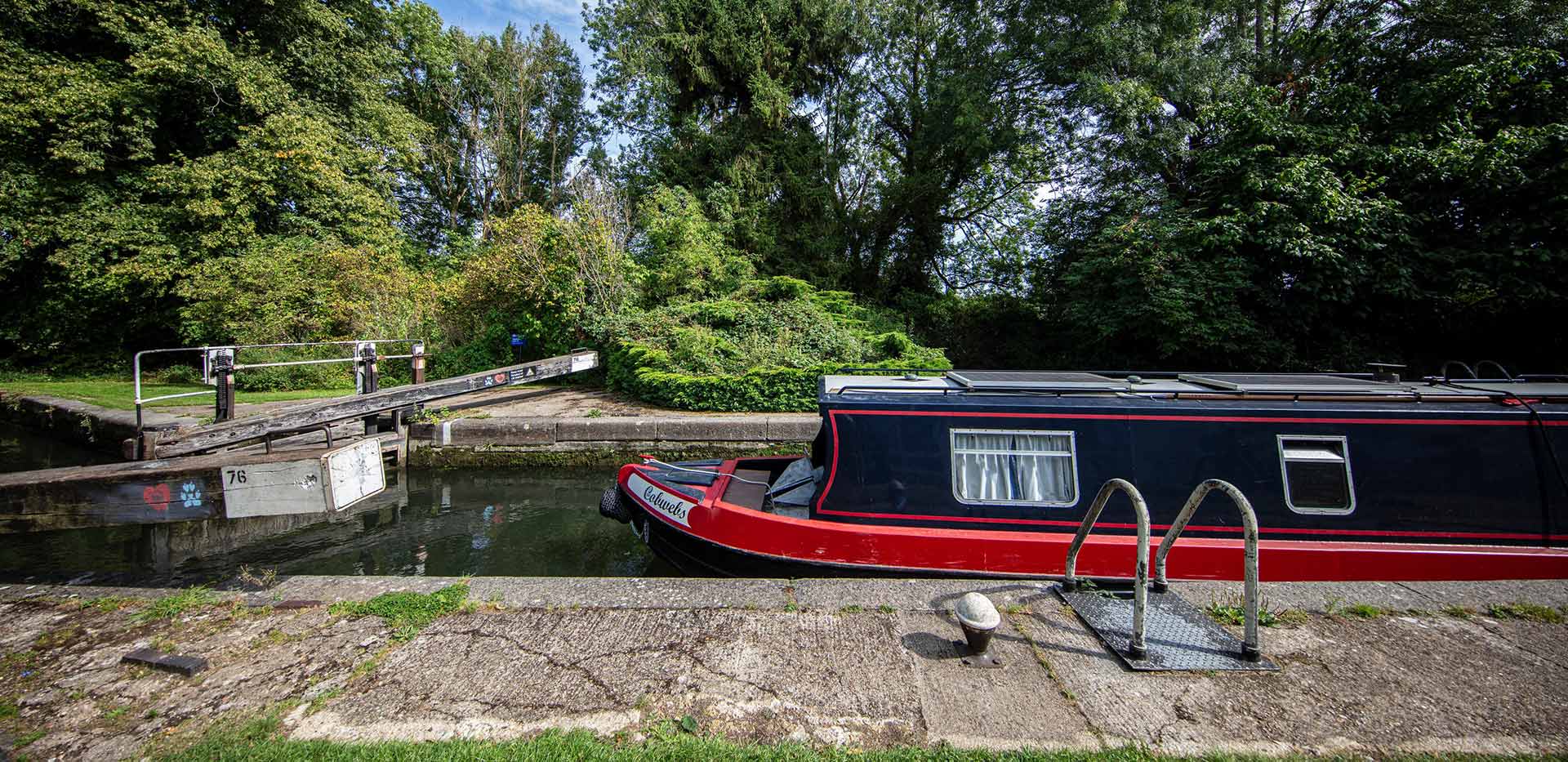 An image of barge boats docked on a local river