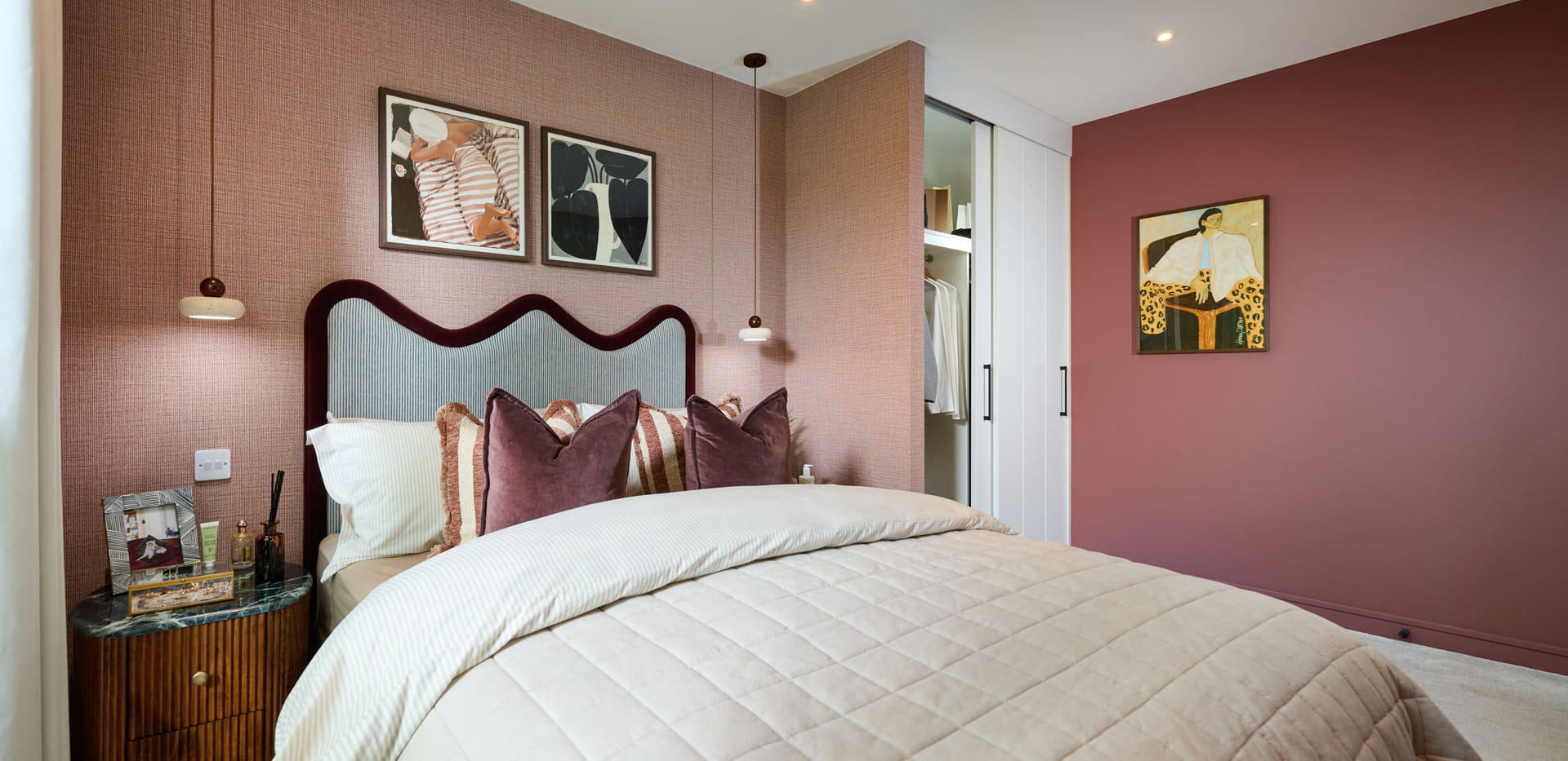 Bedroom decorated in shades of red, built-in wardrobe