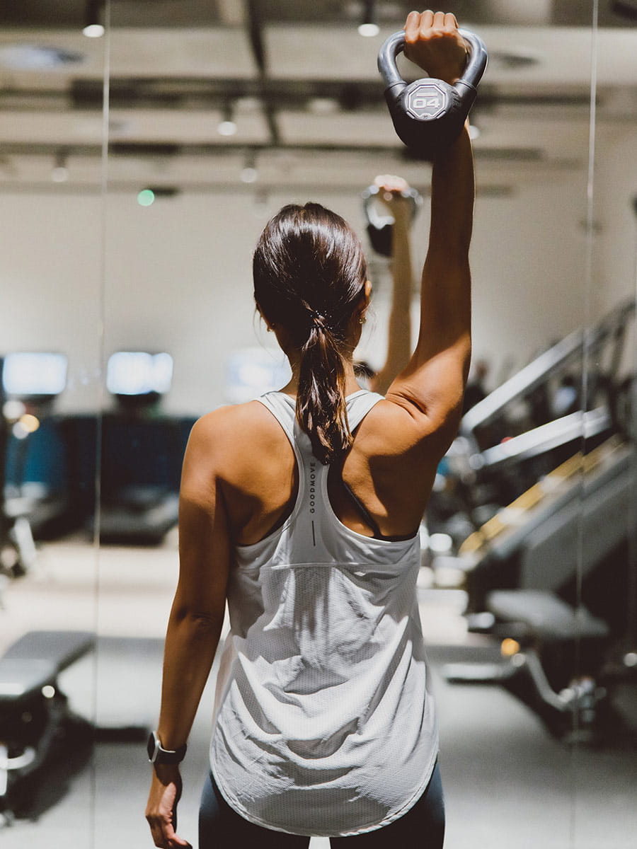 An image of a gym-goer using the weights