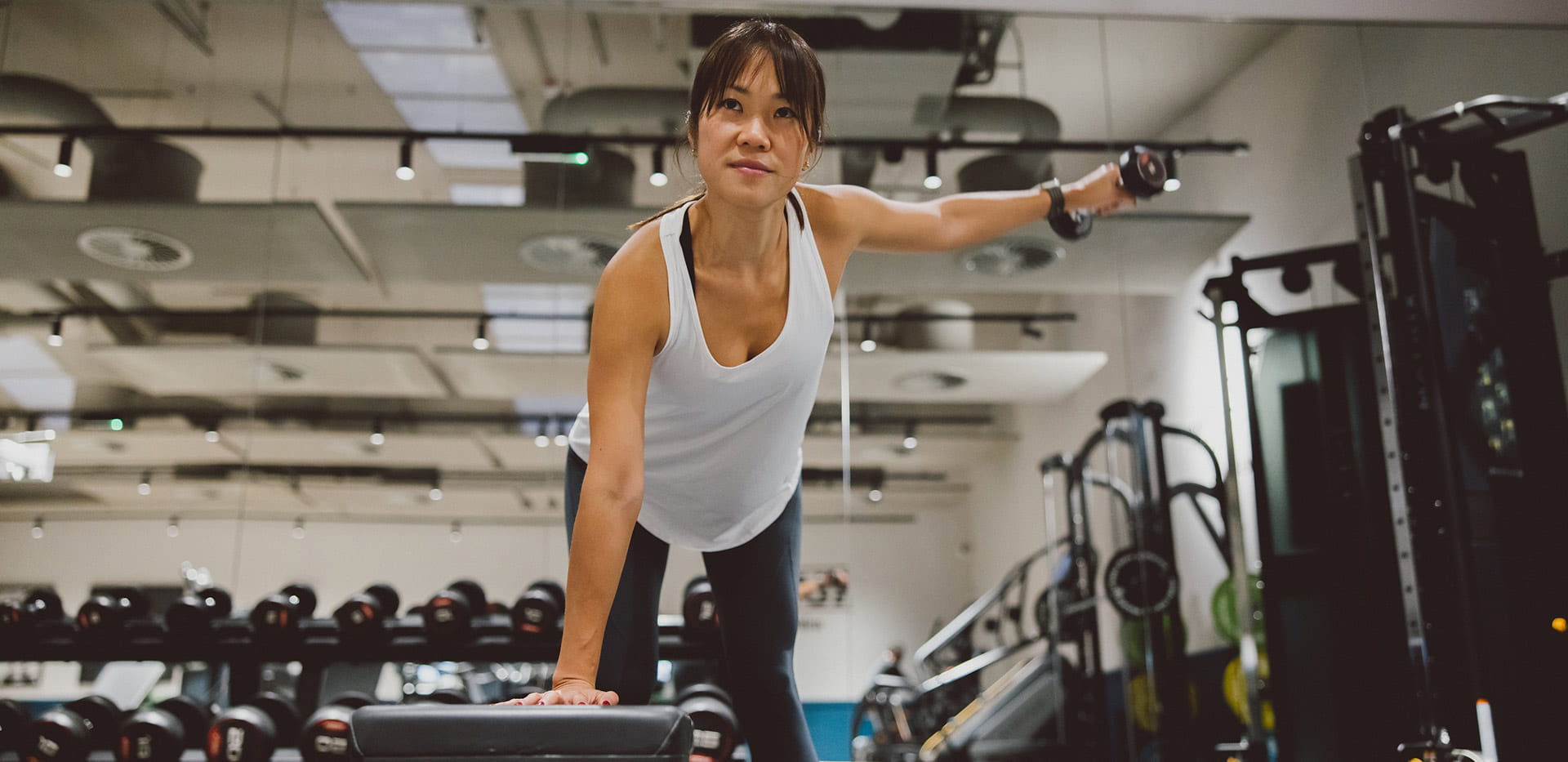 An image of a gym-goer using the weights