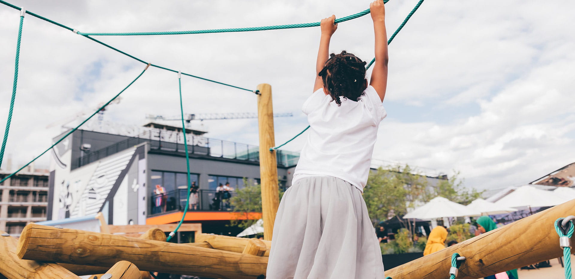 A young child playing on the climbing aparatus at Parkside Yards