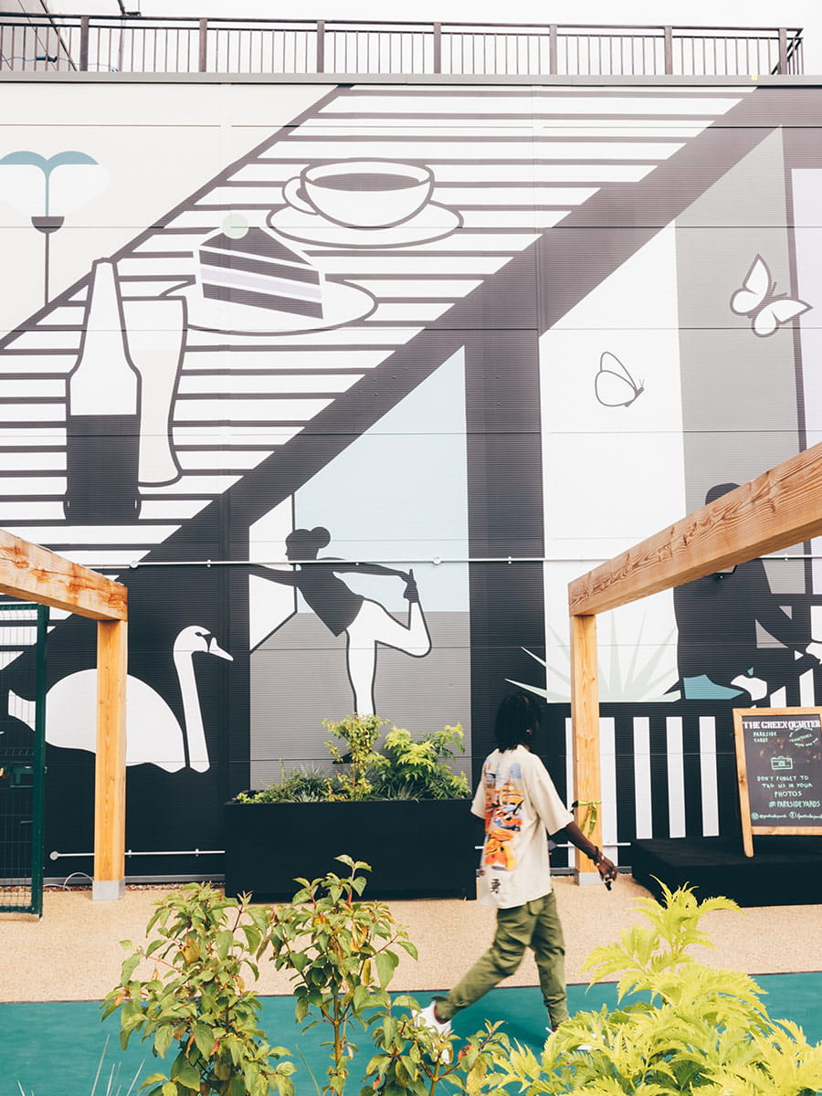 An image of a local resident walking passed the Parkside Yards building