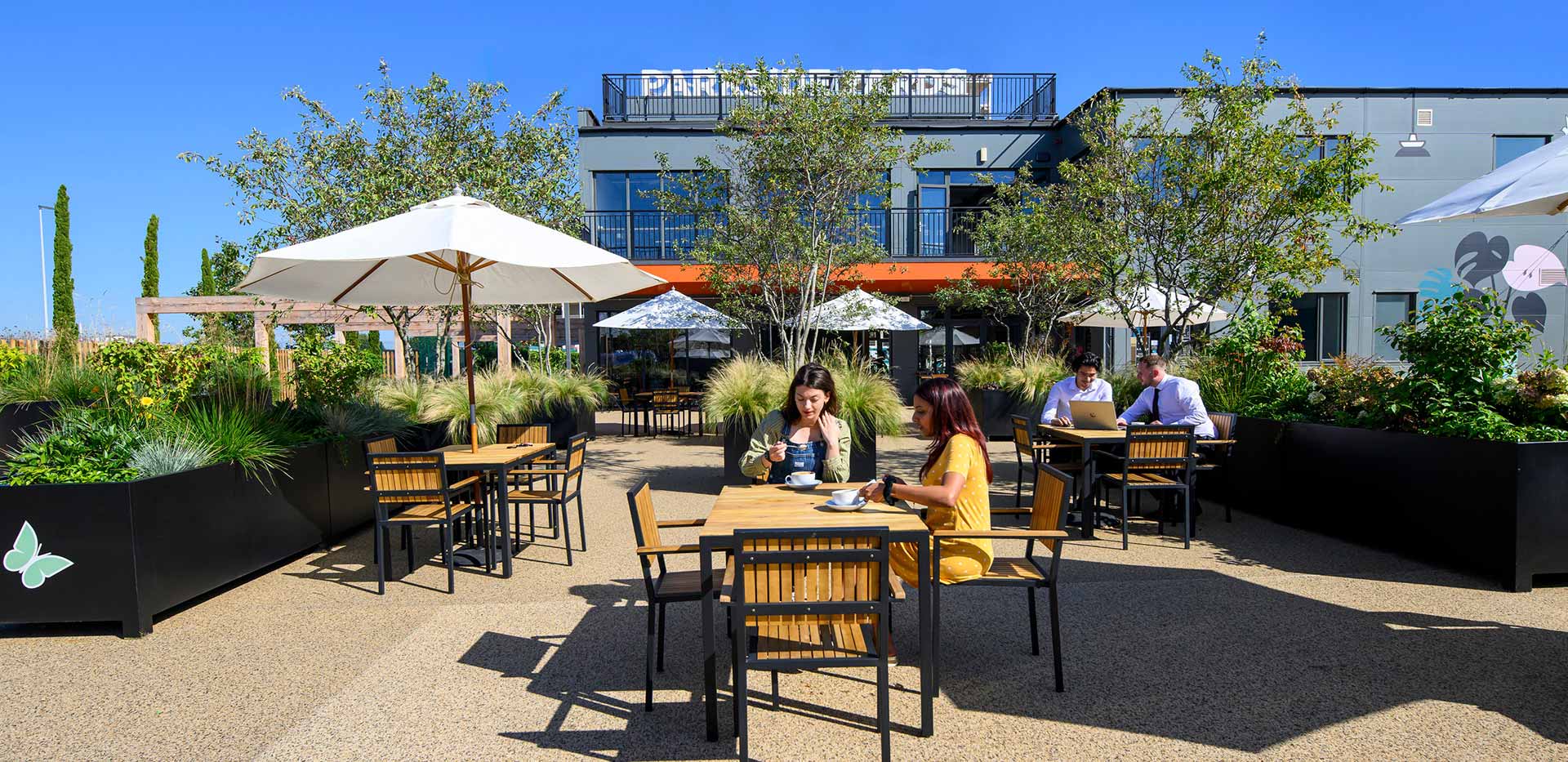 Diners eating outside within the seating area 