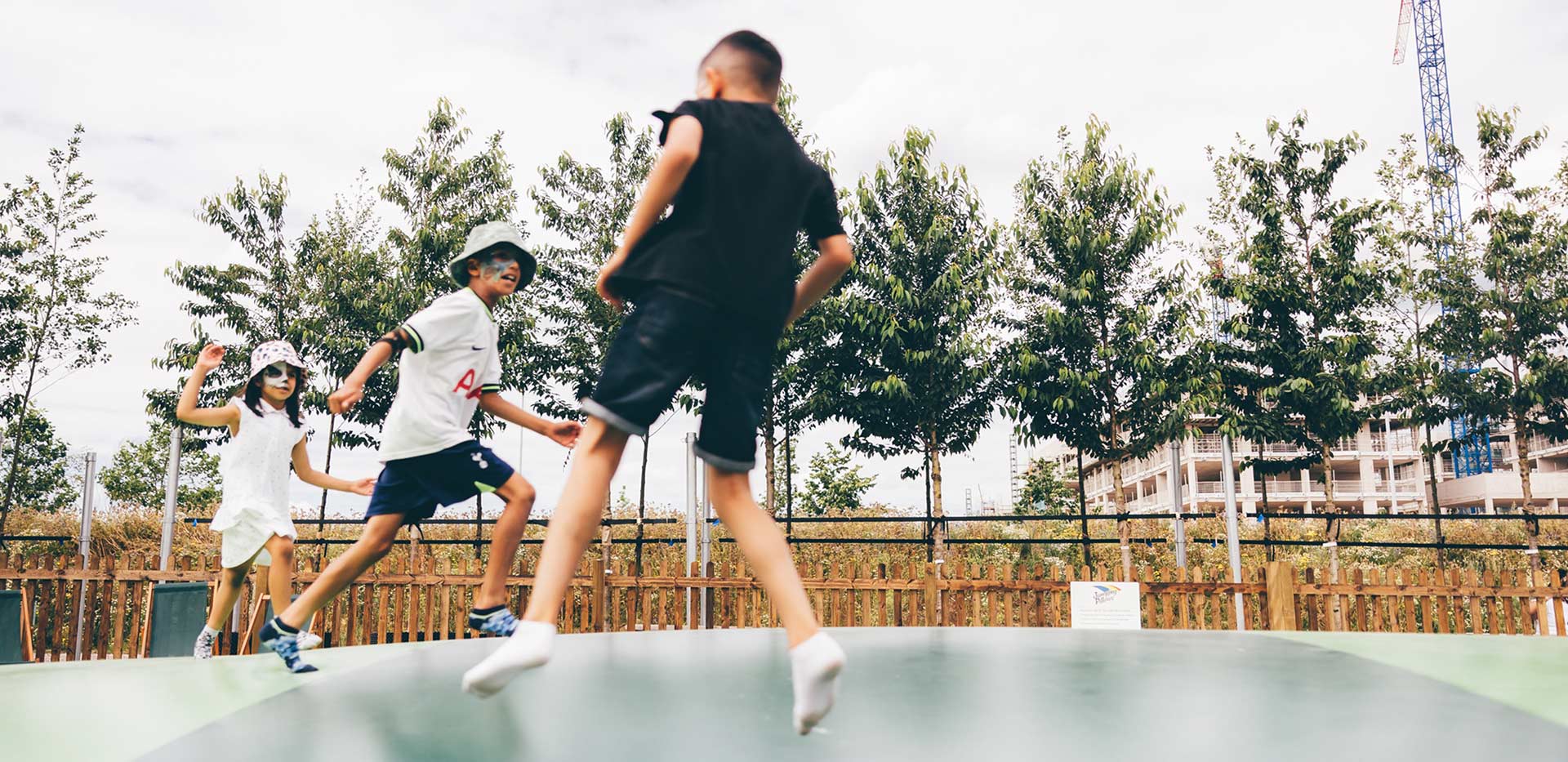 Children enjoying the large inflatable pillow at Parkside Yards