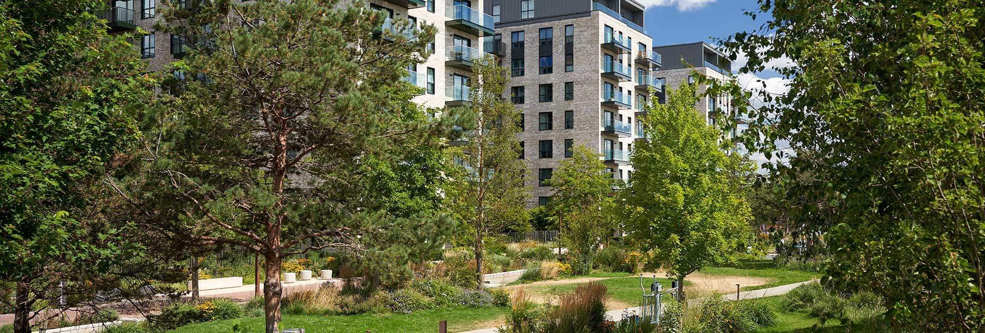 Exterior image of The Green Quarter with trees in foreground