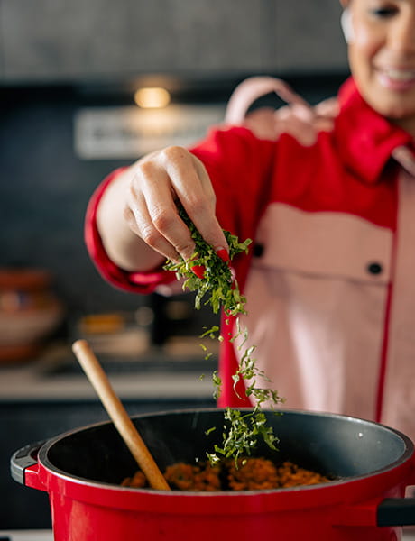 An image of Dipna Anand cooking a meal