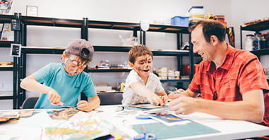 Children doing arts and crafts with adult.