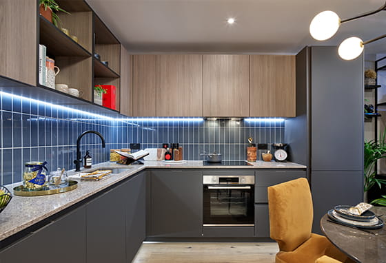 Kitchen with dark grey cabinets and blue tiles
