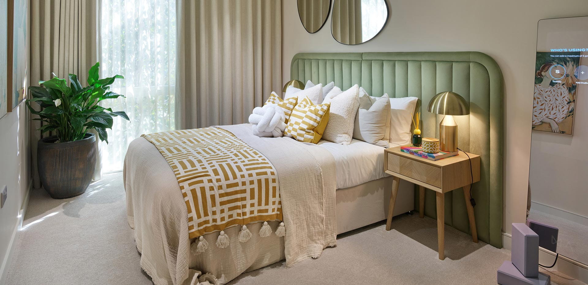 An interior image of a Bedroom with a green headboard at Brickfield House showhome