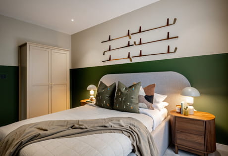 Double bed with contemporary design, bedside tables and wall hanging