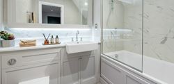 Light themed bathroom with white marble walls