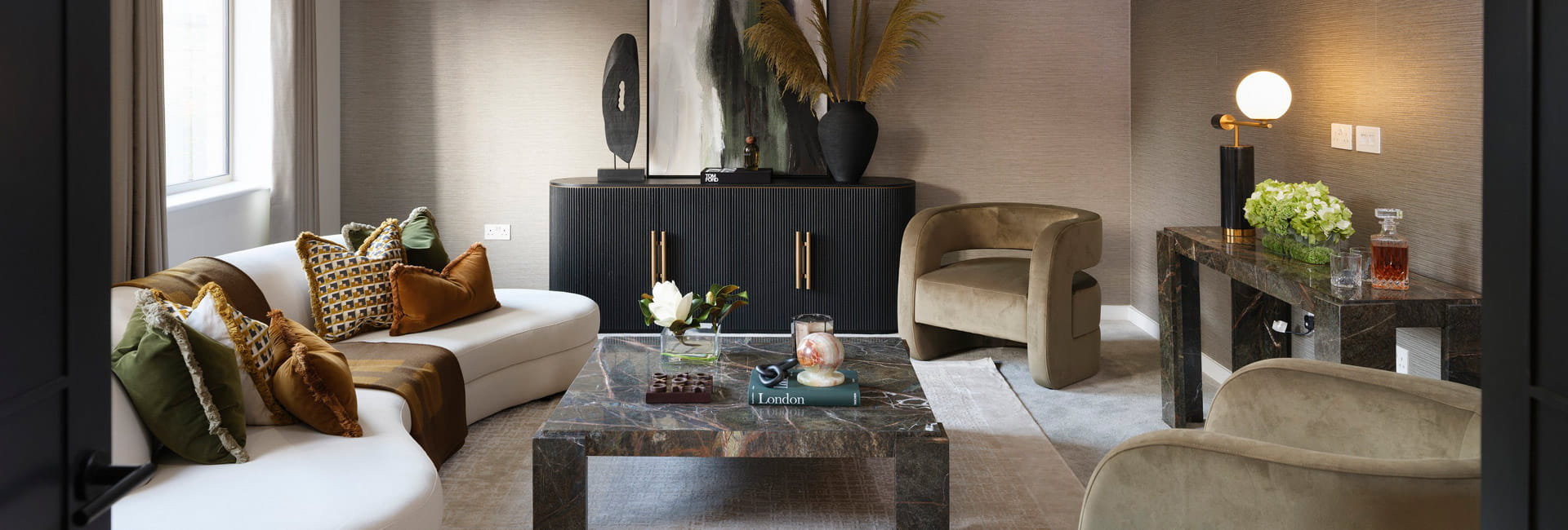 Modern decorated living space or waiting room, with coffee table, seating, cabinets and side table