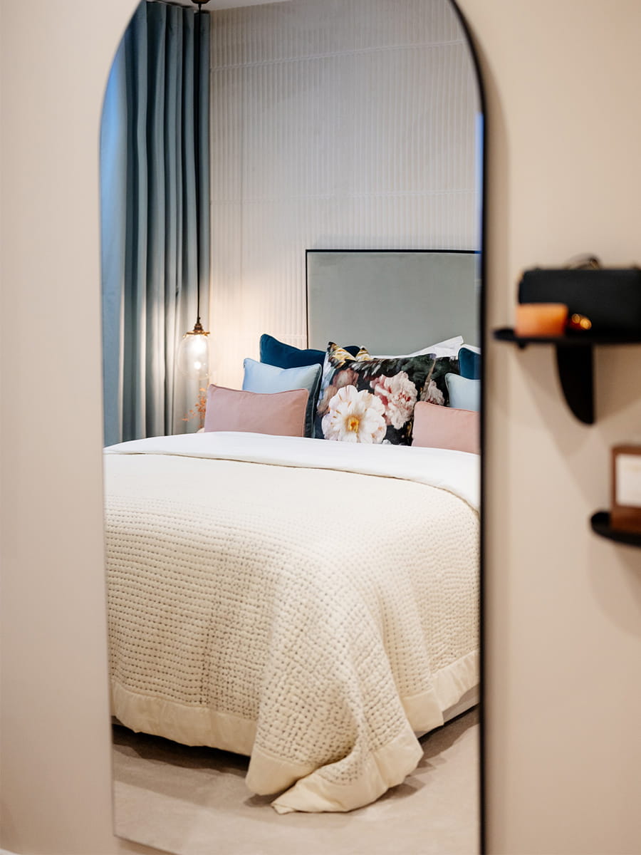 An image of the bed reflecting in the Bedroom Mirror