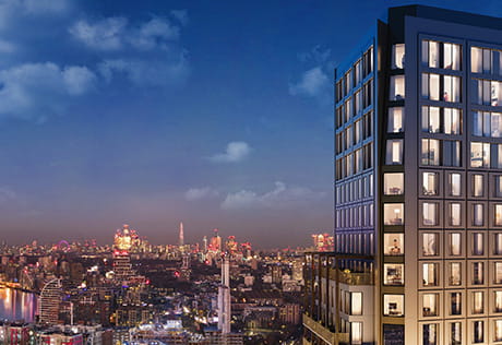 An exterior of Wandsworth Mills at night boasting a stunning London skyline