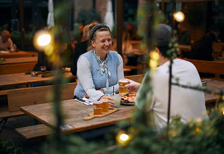A photograph of a couple enjoying their time at a restaurant