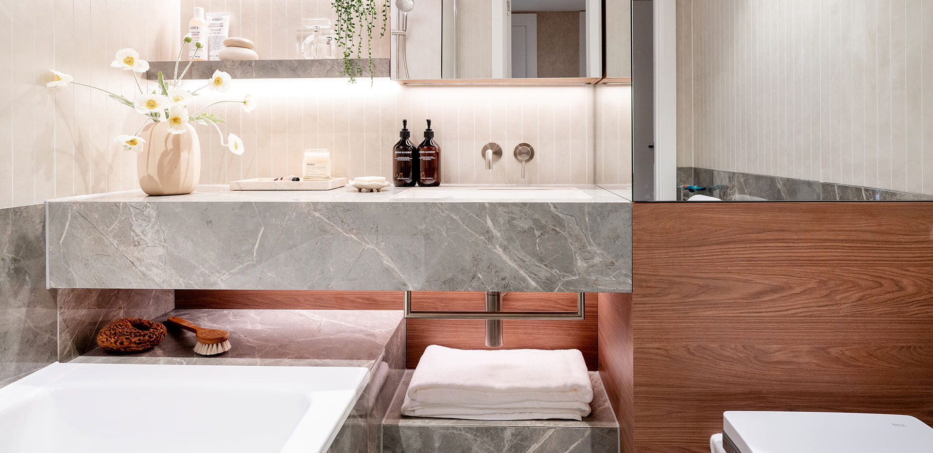 An interior bathroom image with bright lighting and a big mirror