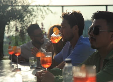 Rooftop bar with customers enjoying cocktails or mocktails in the sun.
