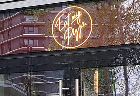 An exterior image of Eat My Pizza at White City Living