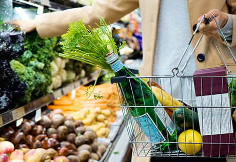 An interior image of a woman shopping in Sainsburys