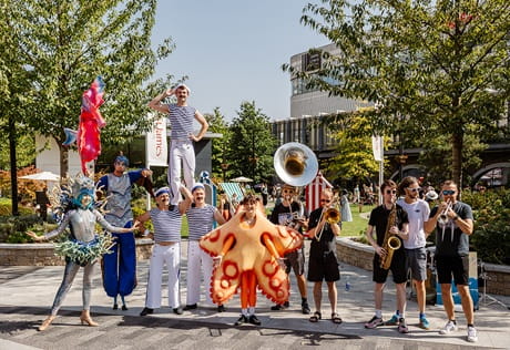 Street performers in flamboyant, colourful dress.