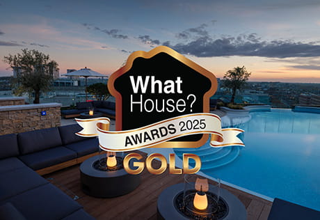 The WhatHouse Gold award in front of the rooftop terrace at White City Living