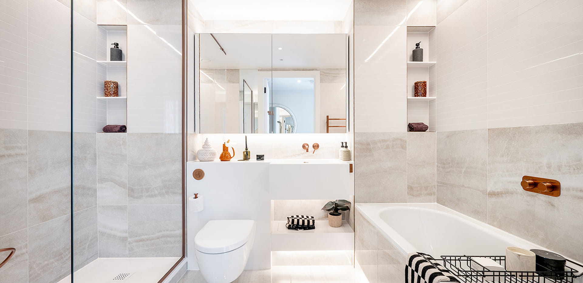 Shower unit and separate bath, modern design with white and stone grey finishes.
