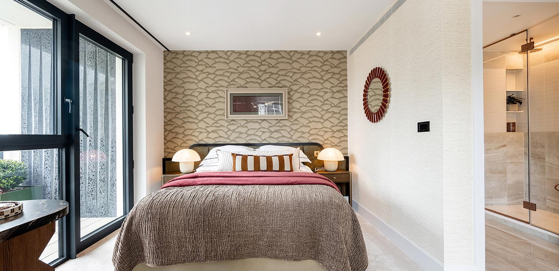 Double bed, wide windows and door onto balcony, partition to separate ensuite.