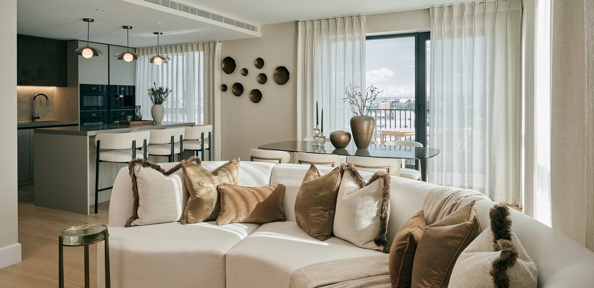 Closeup of sofa in living space, ample natural lighting from tall windows.