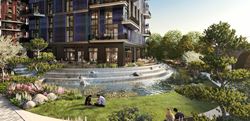 Exterior Image of the landscaped greenery and water feature with residents sitting on the grass