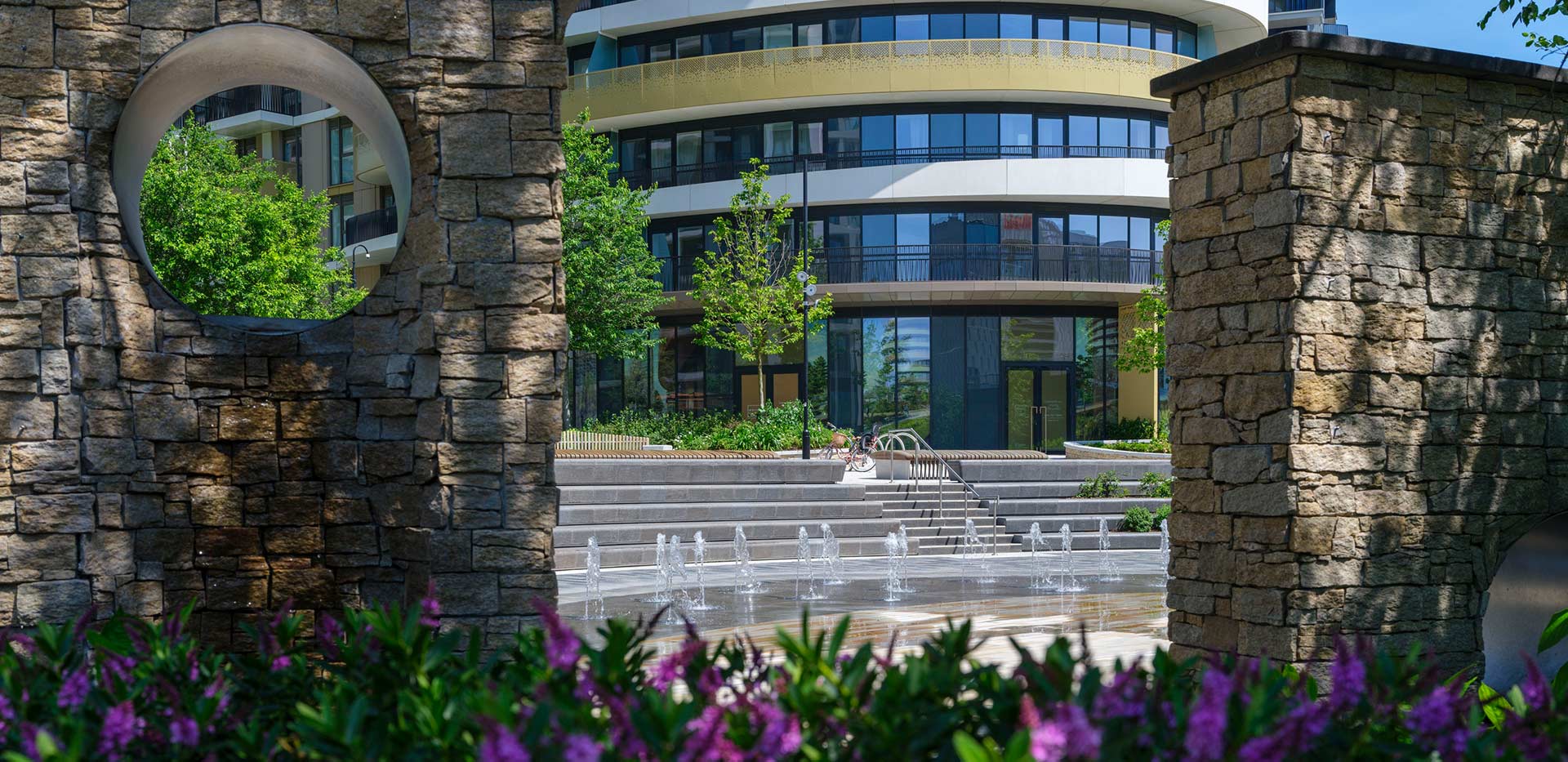 AN image of White City Living, taken through a wall with colourful flowers