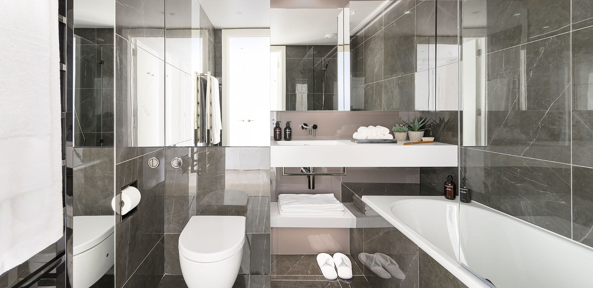 Bathroom with dark, reflective tiles