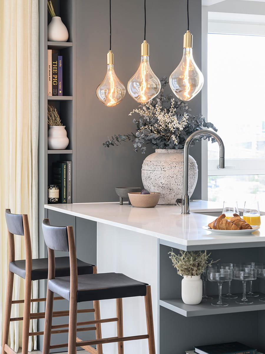 Zoomed in photo of kitchen seating area with white marble countertop