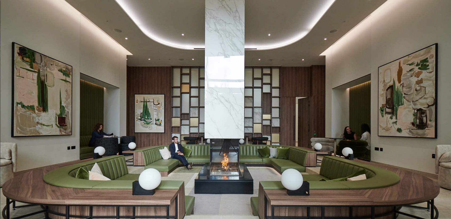 Resident's Facilities - fire pit lounge with green sofas circled around the fire