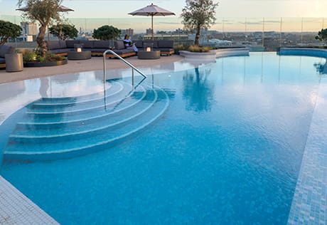 View of a swimming pool and sun lounge chairs.