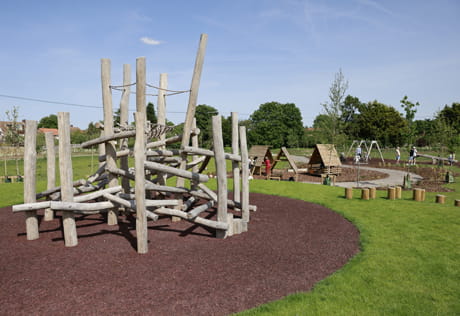 Newly landscaped children's play area with climbing frames