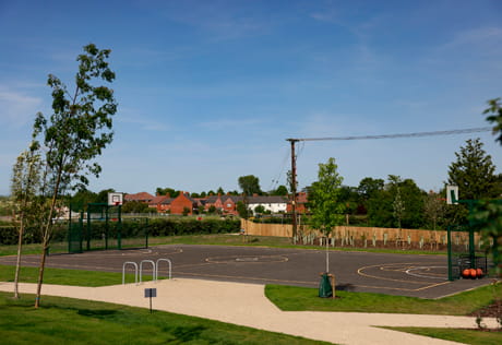 Basketball court, well manicured green spaces and paths