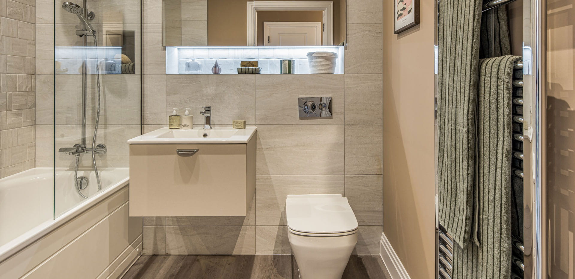 Closeup of bathroom with shower over bath, wash basin, towel rack, sink and toilet