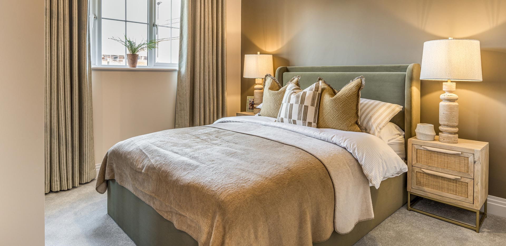 Double bed with bedside tables, decorated in light browns, white and beige