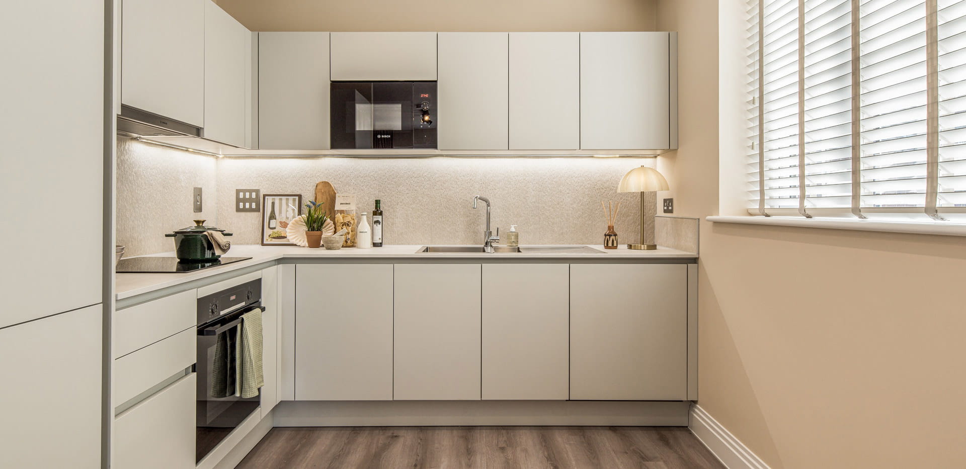 Kitchenette with white appliances and white cupboards