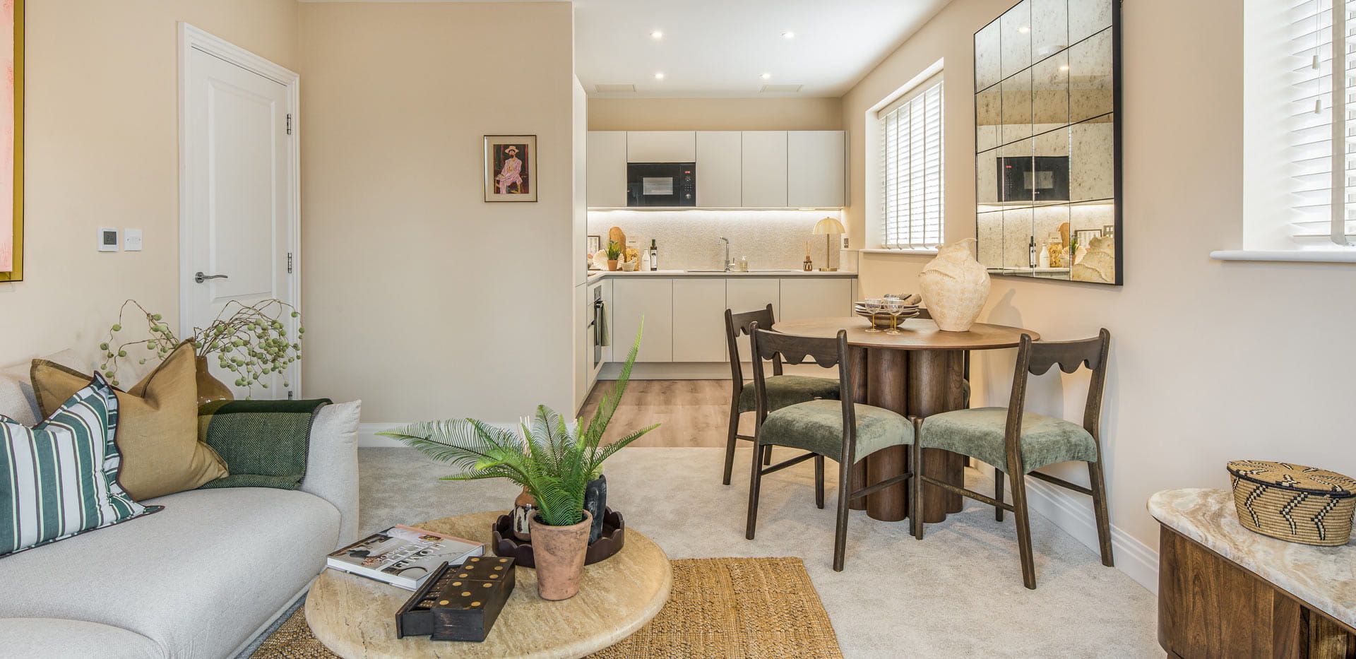 Living room and dining space decorated in beige and light greens and browns