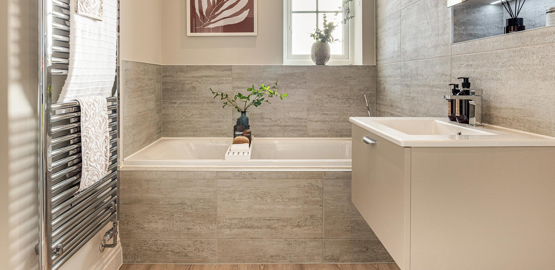 4 bedroom showhome bathroom with a bath and basin