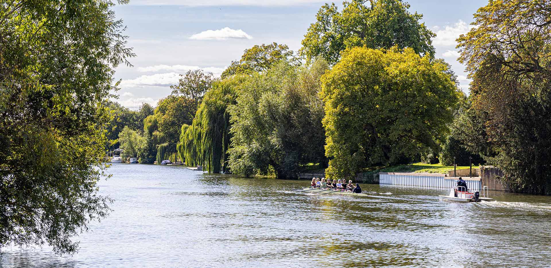An image of a large river with people in canoes