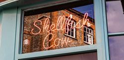 An image of a shop sign selling local shellfish