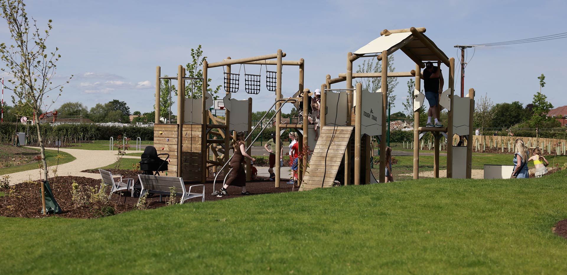 An image of the wooden play and climbing area at The Meadows Keep Play Park